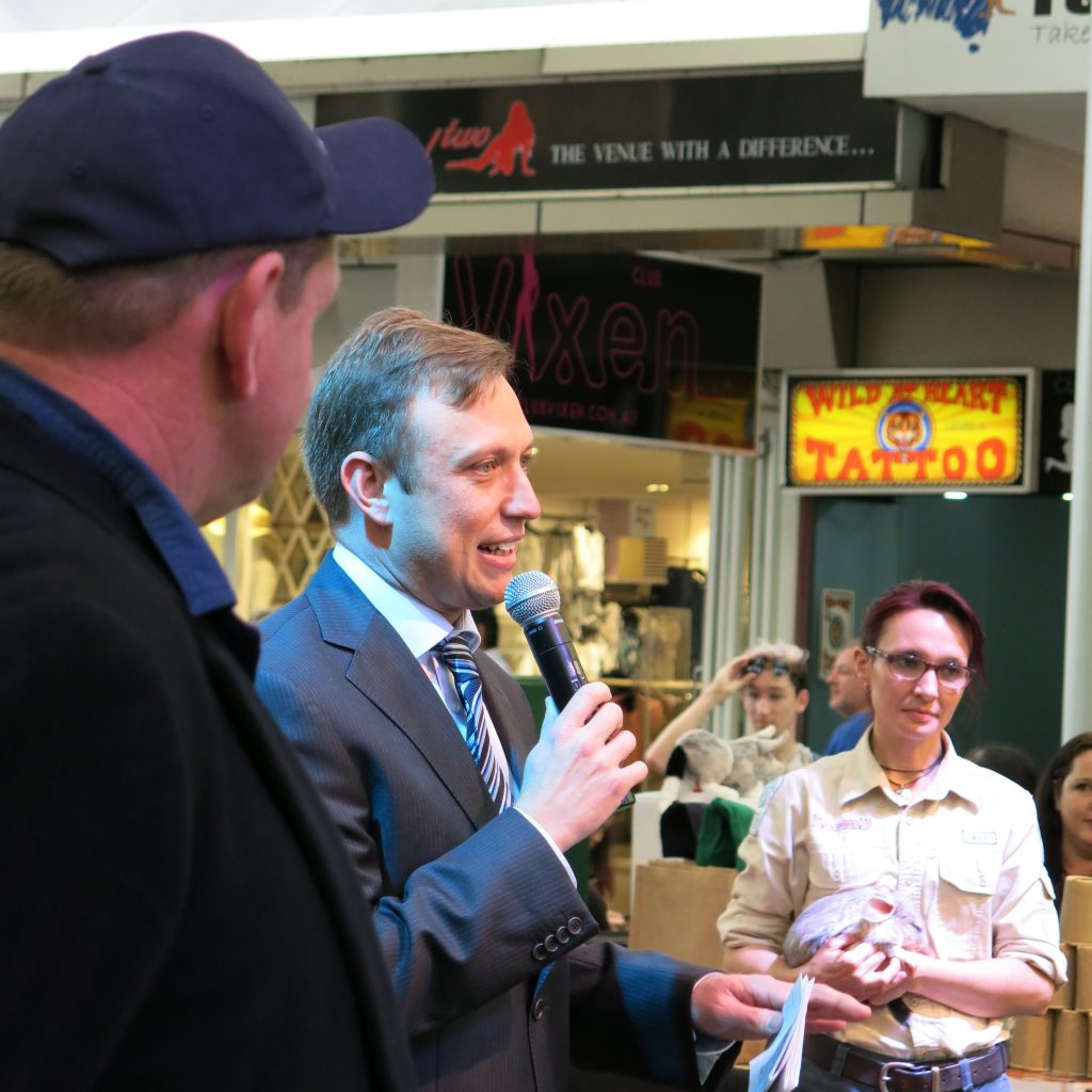 CEO Kev, Steven Miles and a Dreamworld keeper holding a bilby in 2016 at Queens Street Mall, Brisbane.