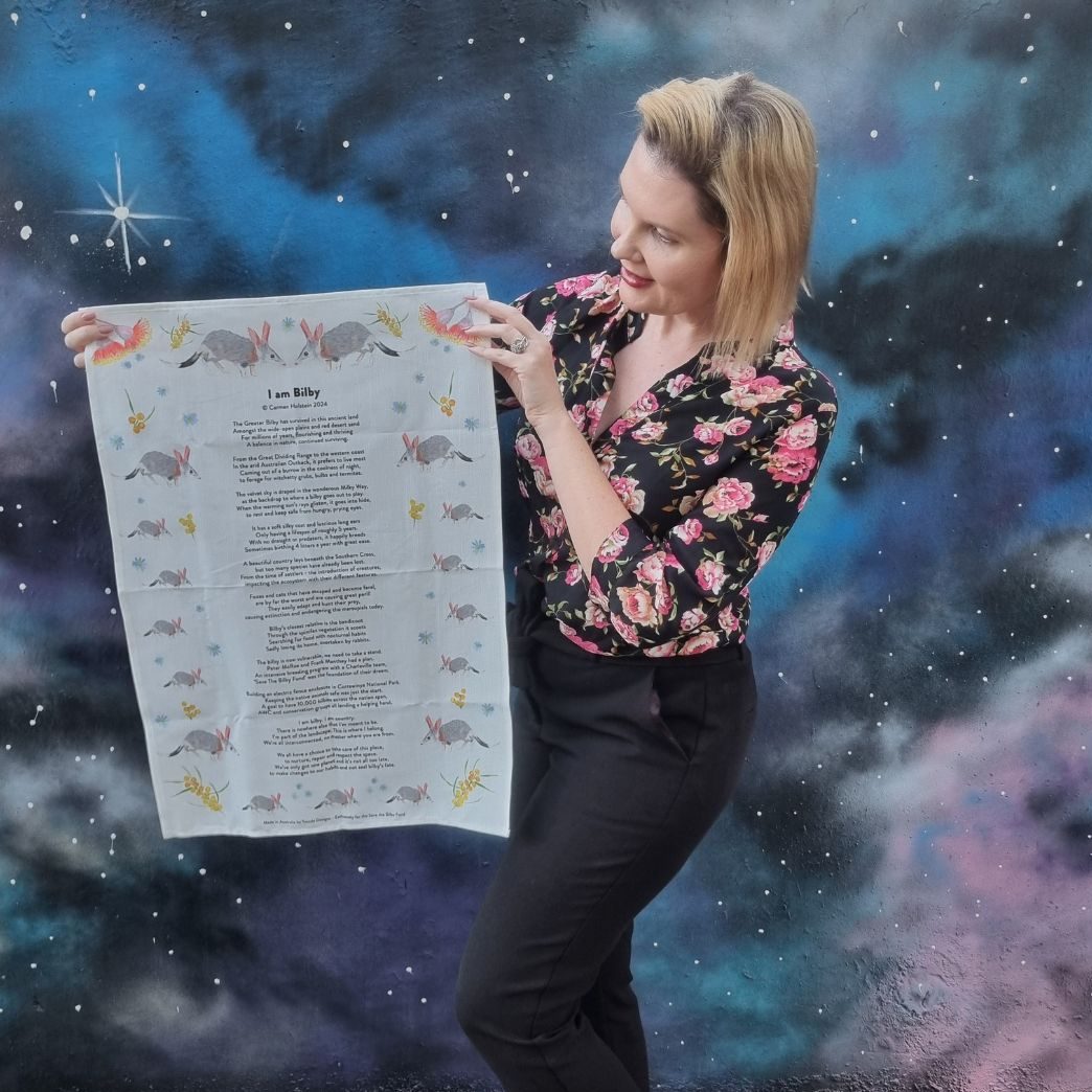 Carmen holding her I am Bilby Tea Towel produced by Twizzle Designs for Save the Bilby Fund.